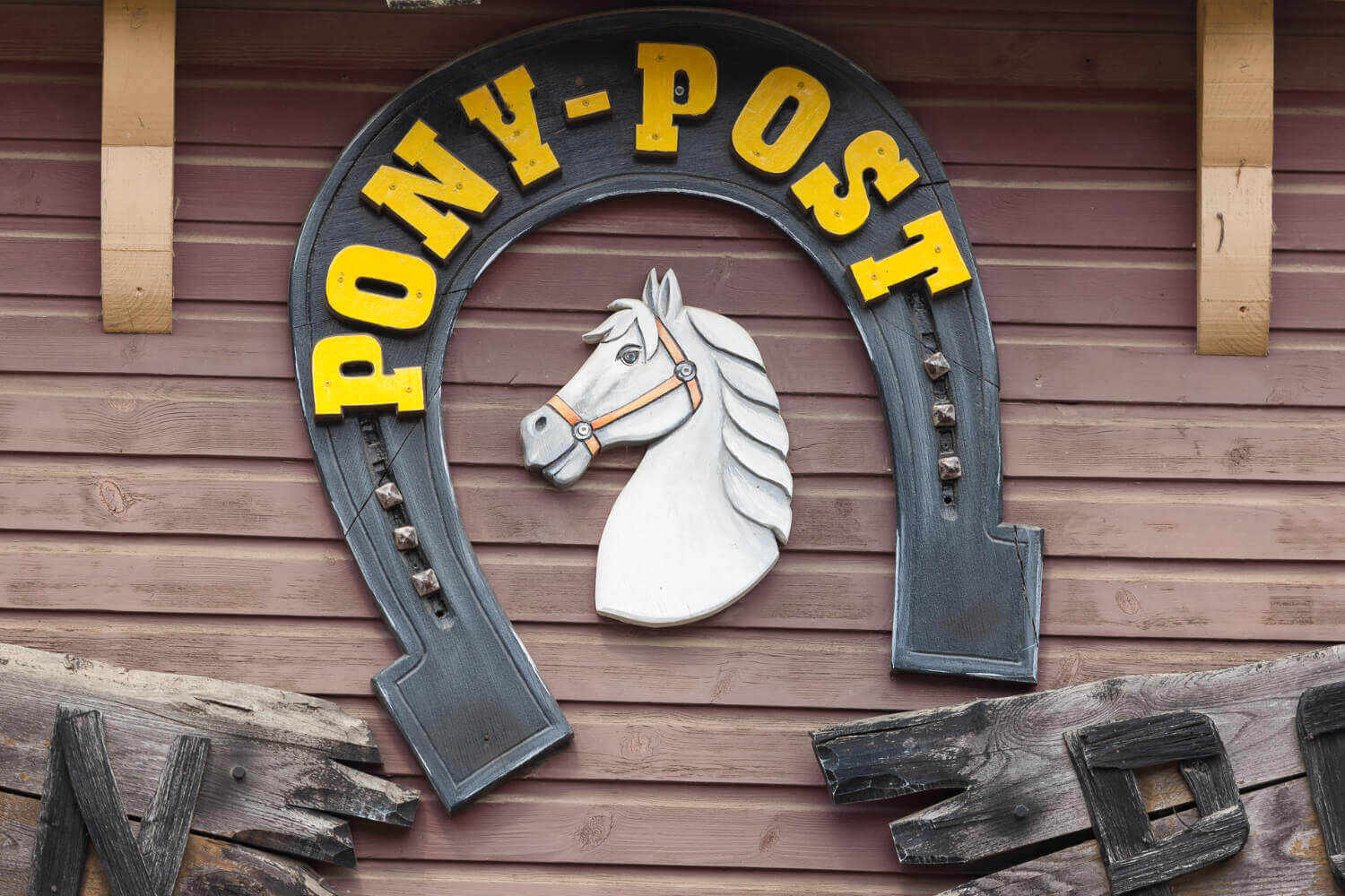 Ein Hufeisen mit dem Namen und ein Pferd ergeben das Logo der Attraktion Pony-Post.